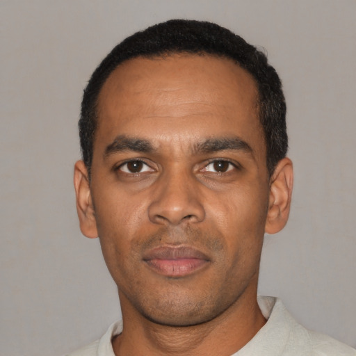 Neutral black young-adult male with short  black hair and brown eyes