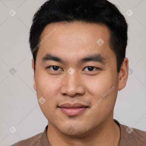 Joyful asian young-adult male with short  black hair and brown eyes