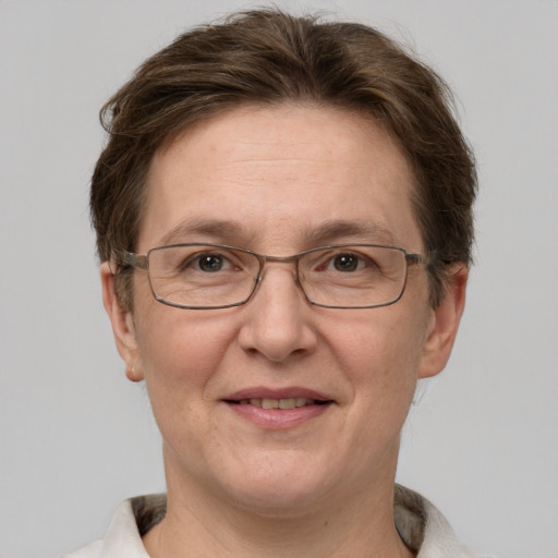 Joyful white adult female with short  brown hair and grey eyes