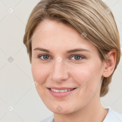 Joyful white young-adult female with medium  brown hair and grey eyes