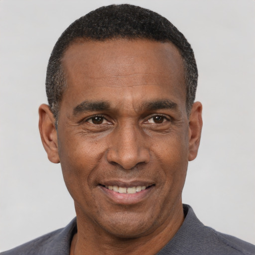Joyful latino adult male with short  black hair and brown eyes