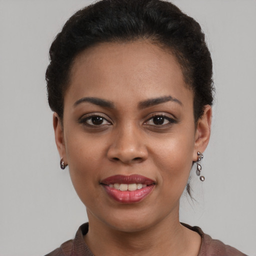 Joyful black young-adult female with short  brown hair and brown eyes