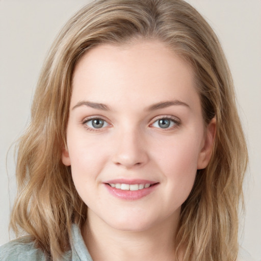 Joyful white young-adult female with medium  brown hair and blue eyes