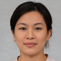 Joyful asian young-adult female with medium  brown hair and brown eyes