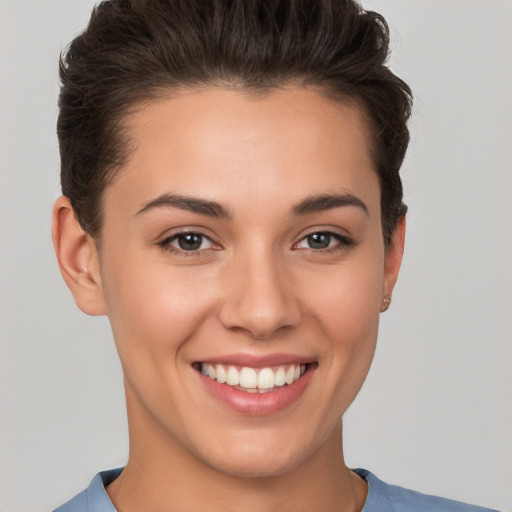 Joyful white young-adult female with short  brown hair and brown eyes