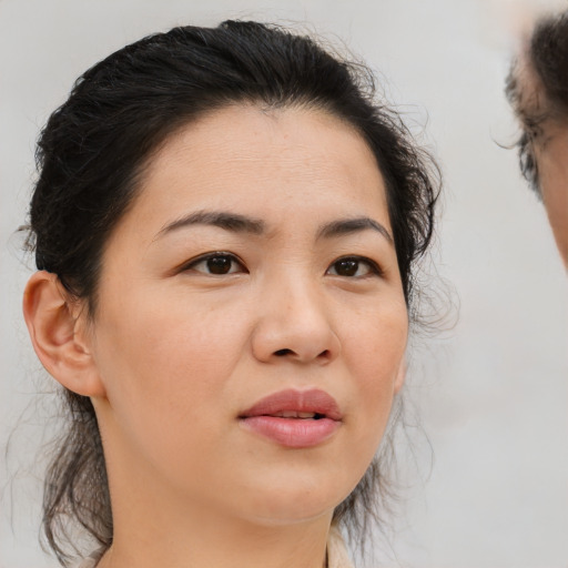 Joyful black adult female with medium  brown hair and brown eyes