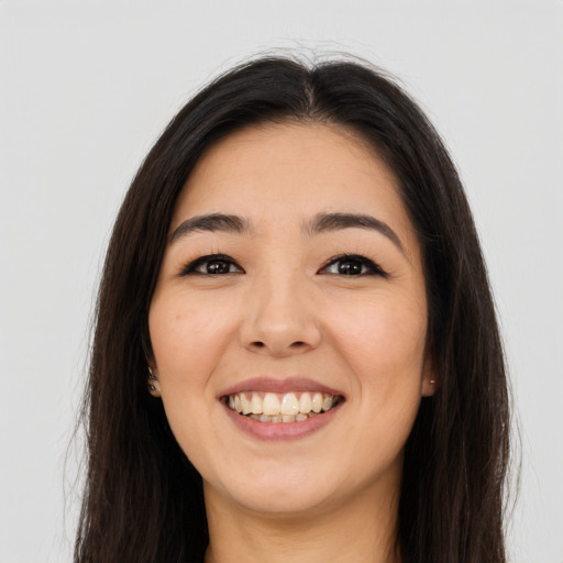 Joyful asian young-adult female with long  brown hair and brown eyes