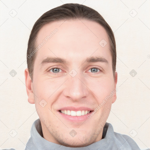 Joyful white young-adult male with short  brown hair and grey eyes