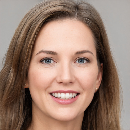 Joyful white young-adult female with long  brown hair and grey eyes