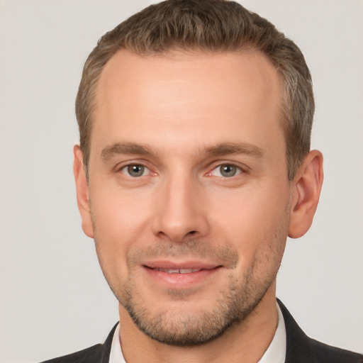 Joyful white young-adult male with short  brown hair and brown eyes