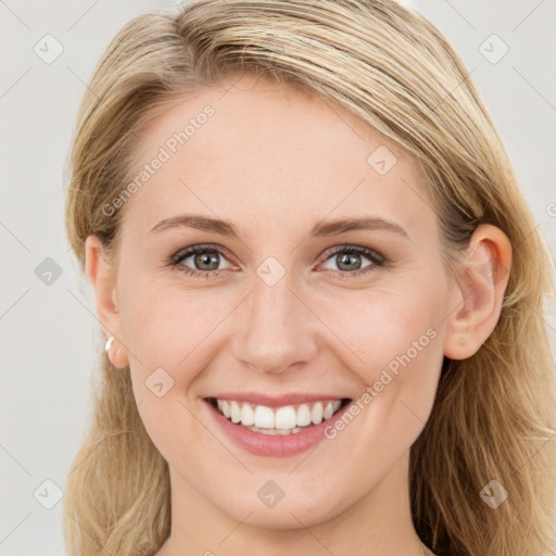 Joyful white young-adult female with long  brown hair and blue eyes