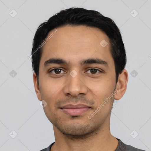 Joyful latino young-adult male with short  black hair and brown eyes