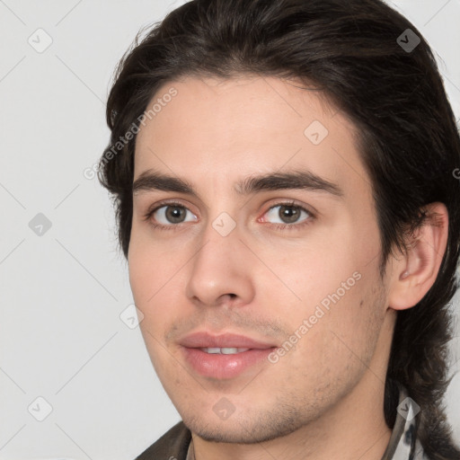 Joyful white young-adult male with medium  brown hair and brown eyes