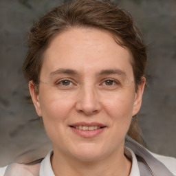 Joyful white adult female with medium  brown hair and brown eyes