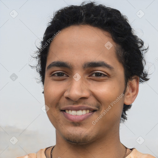 Joyful latino young-adult male with short  brown hair and brown eyes