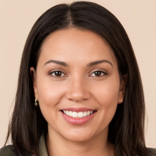 Joyful white young-adult female with long  brown hair and brown eyes