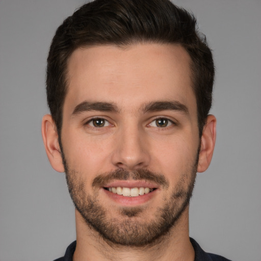 Joyful white young-adult male with short  brown hair and brown eyes