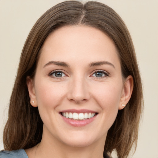 Joyful white young-adult female with medium  brown hair and grey eyes