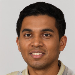 Joyful latino young-adult male with short  black hair and brown eyes