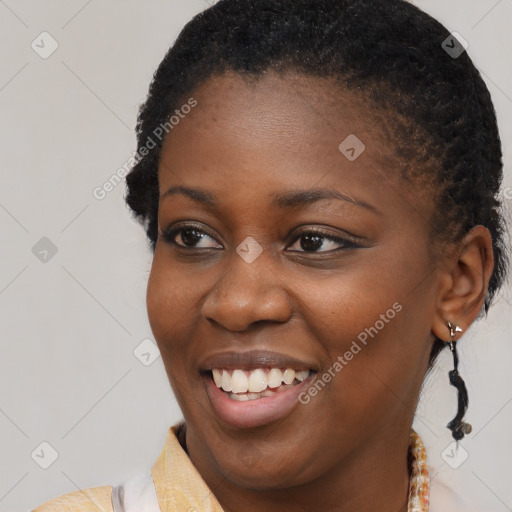 Joyful black young-adult female with short  brown hair and brown eyes