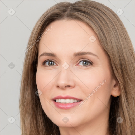 Joyful white young-adult female with long  brown hair and brown eyes