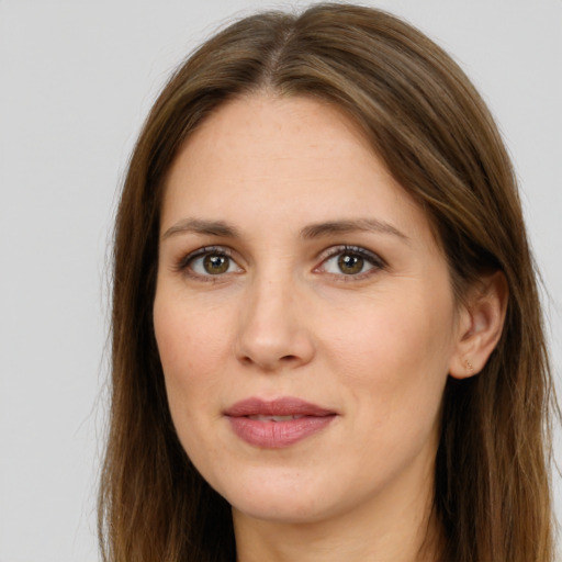 Joyful white adult female with long  brown hair and brown eyes