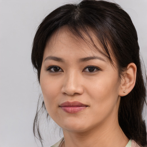Joyful asian young-adult female with medium  brown hair and brown eyes