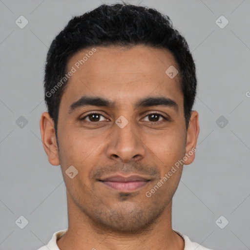 Joyful latino young-adult male with short  black hair and brown eyes