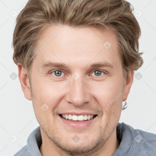 Joyful white adult male with short  brown hair and grey eyes