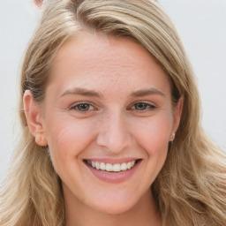 Joyful white young-adult female with long  brown hair and blue eyes