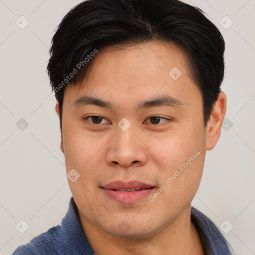 Joyful asian young-adult male with short  brown hair and brown eyes