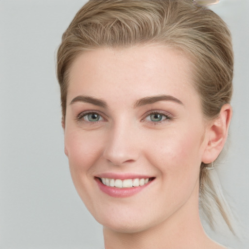 Joyful white young-adult female with medium  brown hair and blue eyes