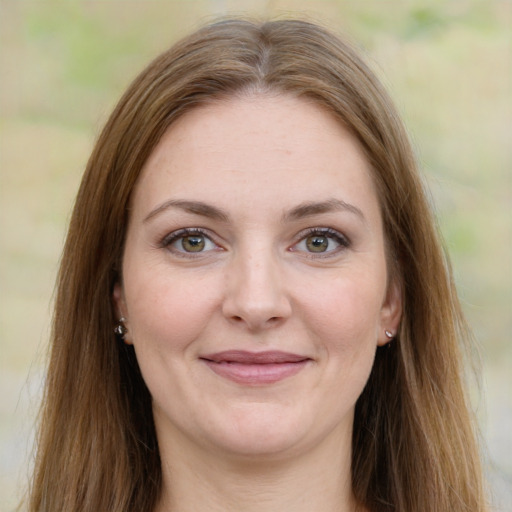 Joyful white young-adult female with long  brown hair and green eyes