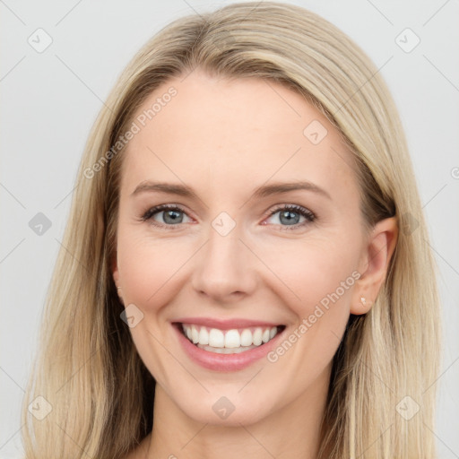 Joyful white young-adult female with long  brown hair and blue eyes