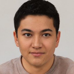 Joyful latino young-adult male with short  brown hair and brown eyes