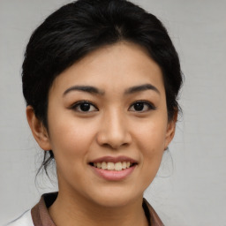 Joyful asian young-adult female with medium  black hair and brown eyes