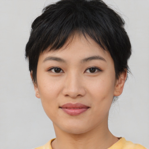 Joyful asian young-adult female with short  brown hair and brown eyes