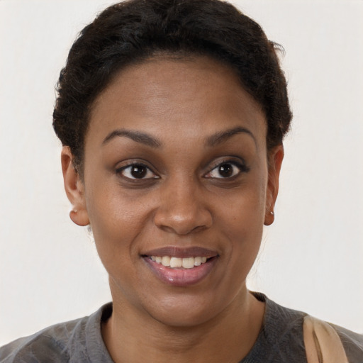 Joyful black young-adult female with short  brown hair and brown eyes