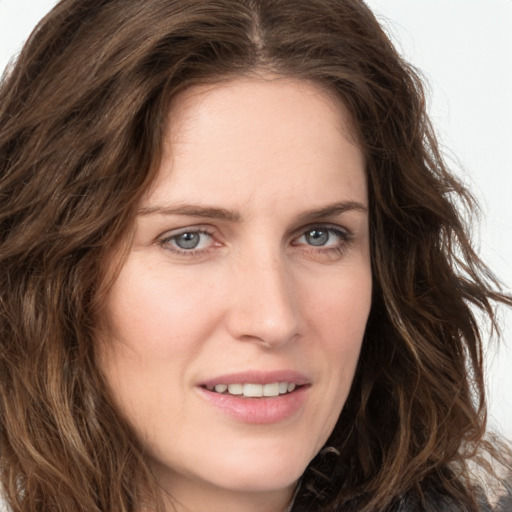 Joyful white young-adult female with long  brown hair and green eyes