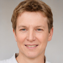 Joyful white adult male with short  brown hair and grey eyes