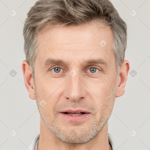 Joyful white adult male with short  brown hair and grey eyes