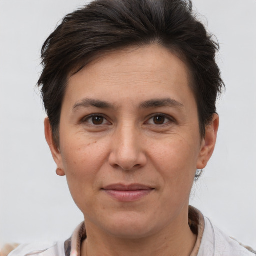 Joyful white adult female with short  brown hair and brown eyes