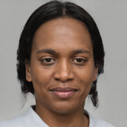 Joyful black adult female with medium  black hair and brown eyes
