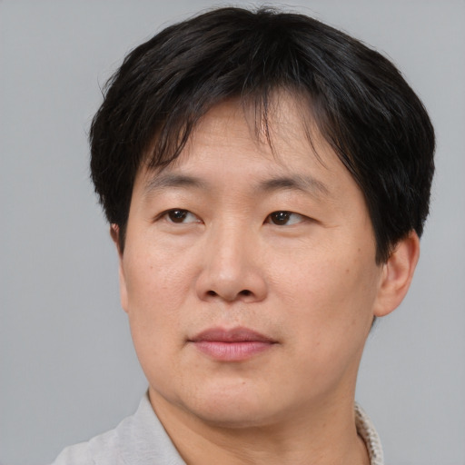 Neutral asian adult male with short  brown hair and brown eyes