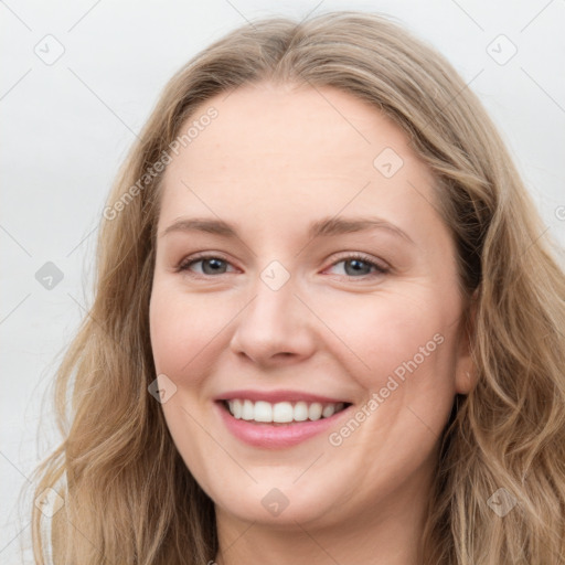 Joyful white young-adult female with long  brown hair and blue eyes