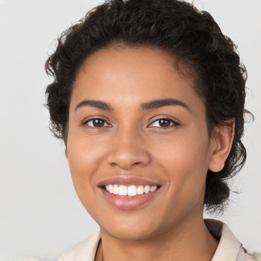 Joyful latino young-adult female with short  brown hair and brown eyes