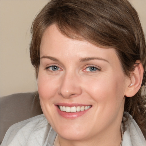 Joyful white young-adult female with medium  brown hair and blue eyes