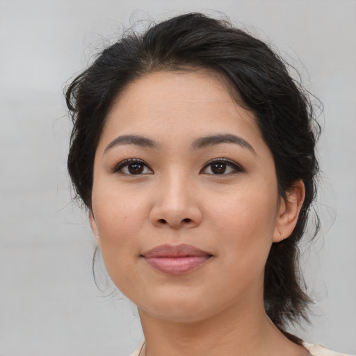 Joyful asian young-adult female with medium  brown hair and brown eyes
