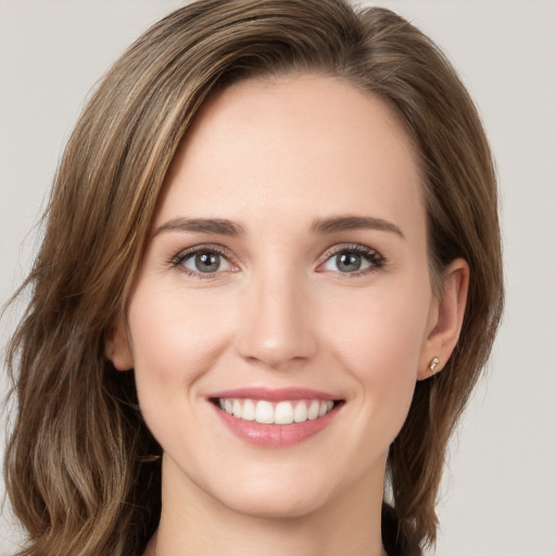 Joyful white young-adult female with long  brown hair and green eyes