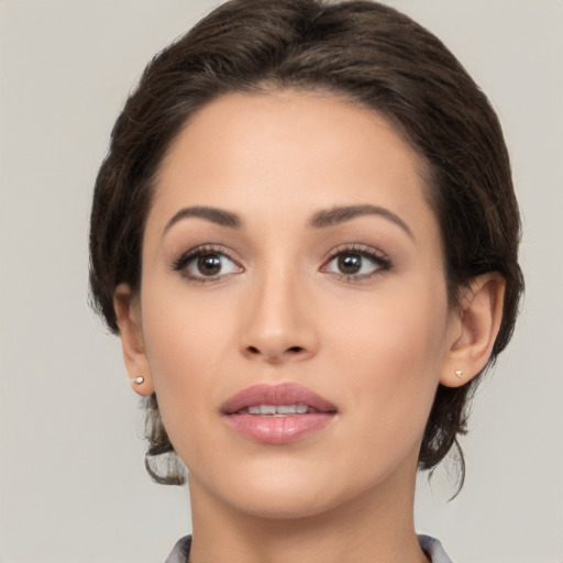 Joyful white young-adult female with medium  brown hair and brown eyes